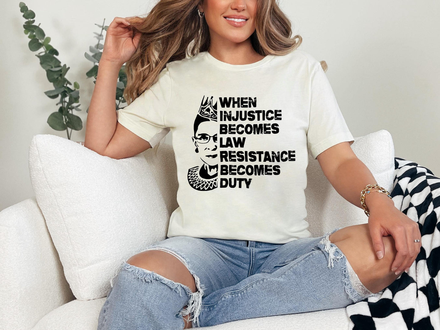 a woman sitting on a couch wearing a t - shirt that says when justice becomes
