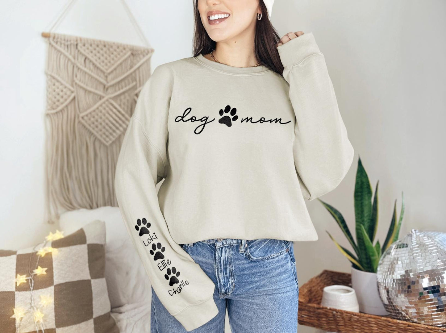 a woman wearing a dog mom sweater with paw prints