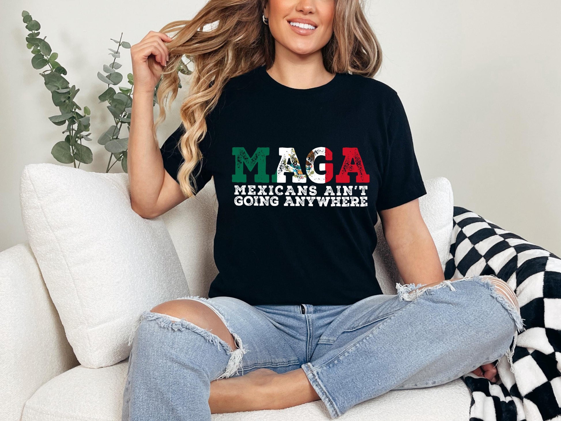 a woman sitting on a couch wearing a black shirt