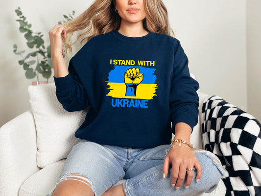 a woman sitting on a couch wearing a sweatshirt that says i stand with ukraine