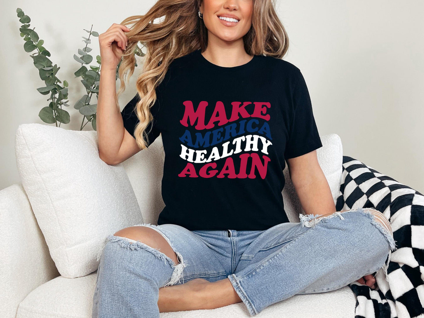 a woman sitting on a couch wearing a make america t - shirt