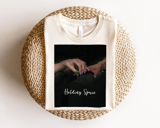 a white t - shirt with a picture of a woman&#39;s hand on it
