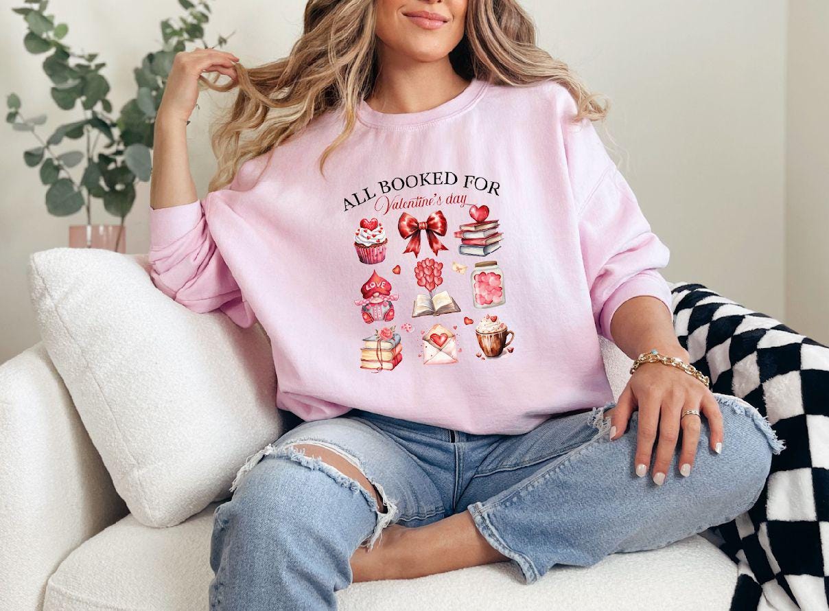 a woman sitting on a couch wearing a pink shirt