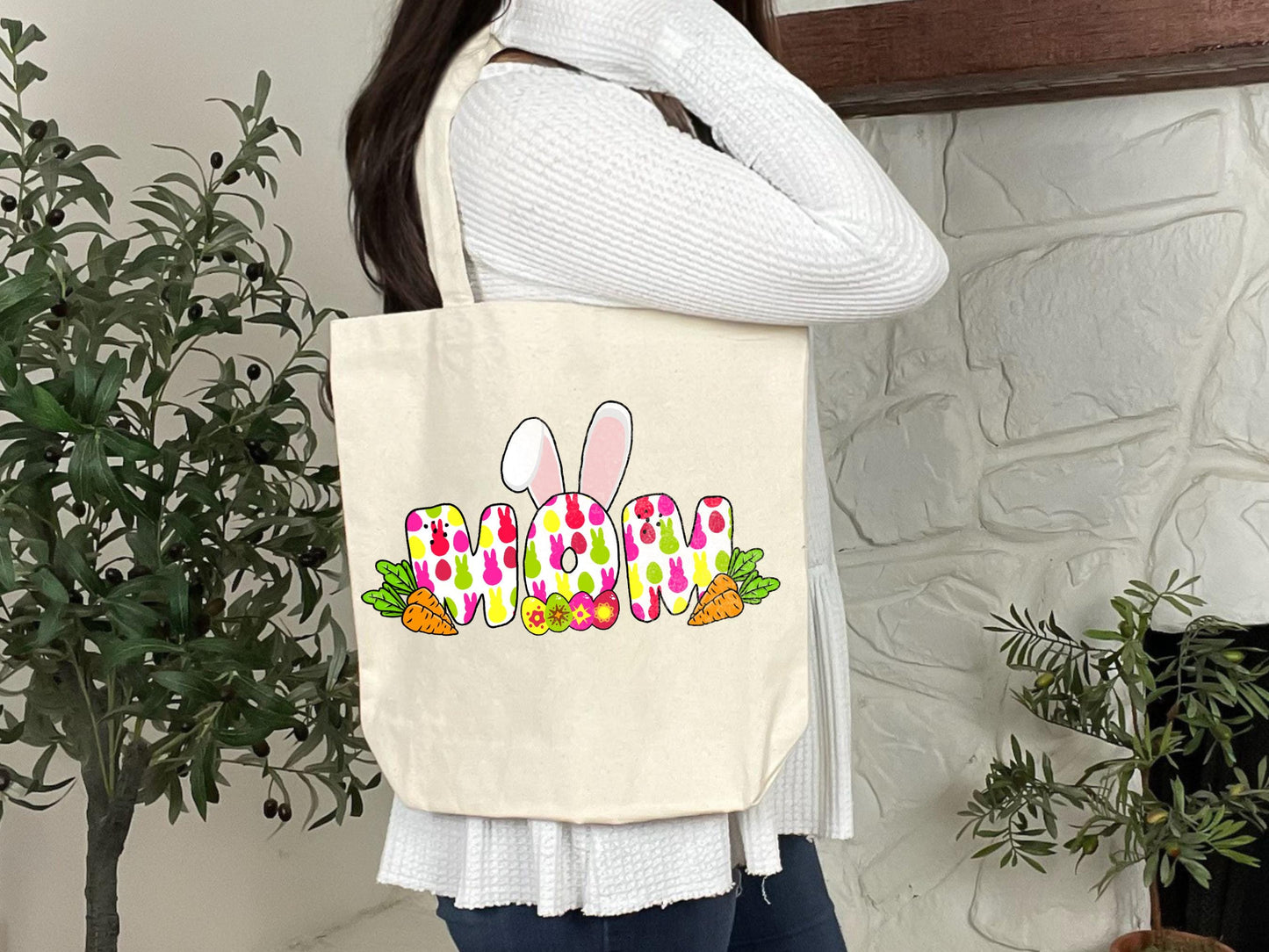 a woman holding a tote bag that says happy easter
