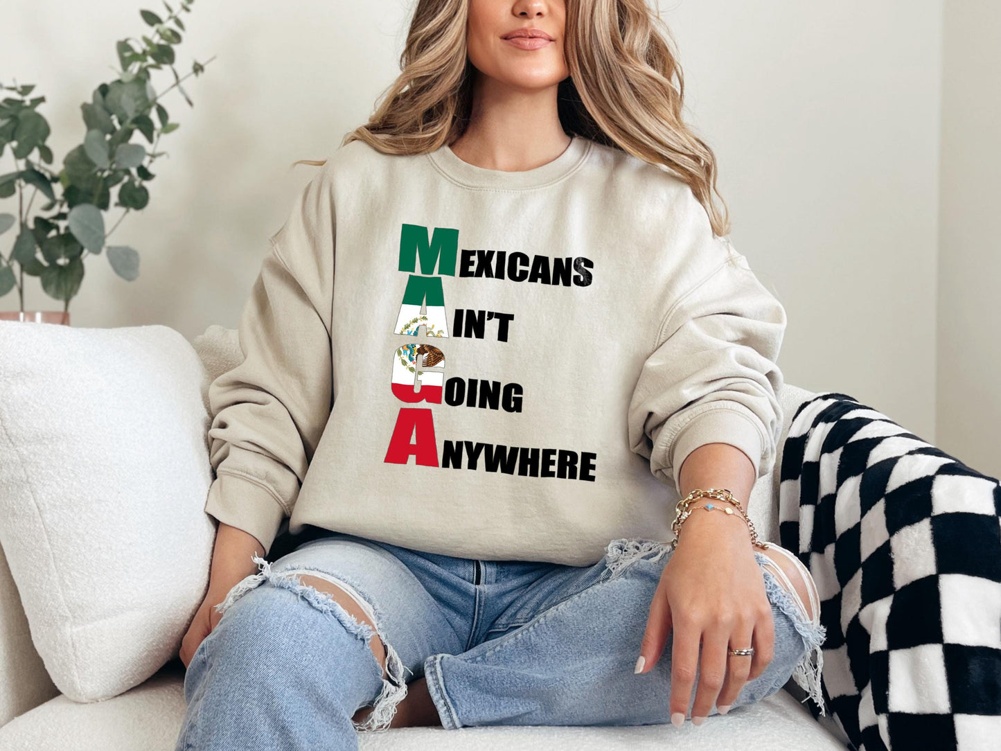 a woman sitting on a couch wearing a sweatshirt