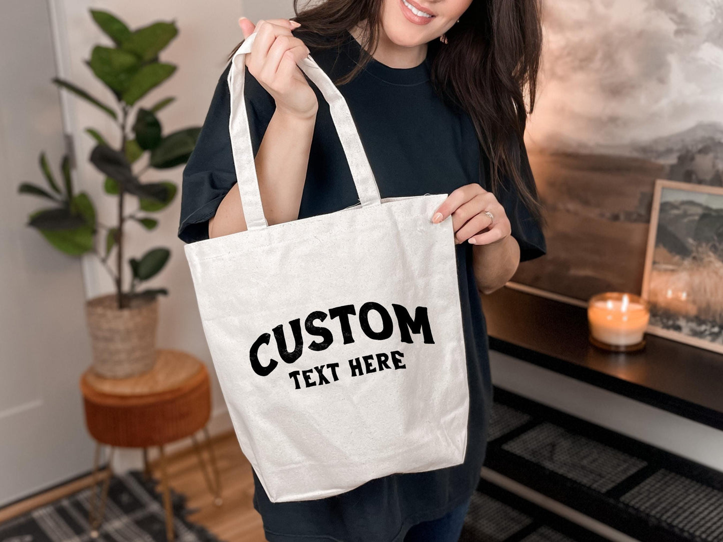 a woman holding a white tote bag with a custom text