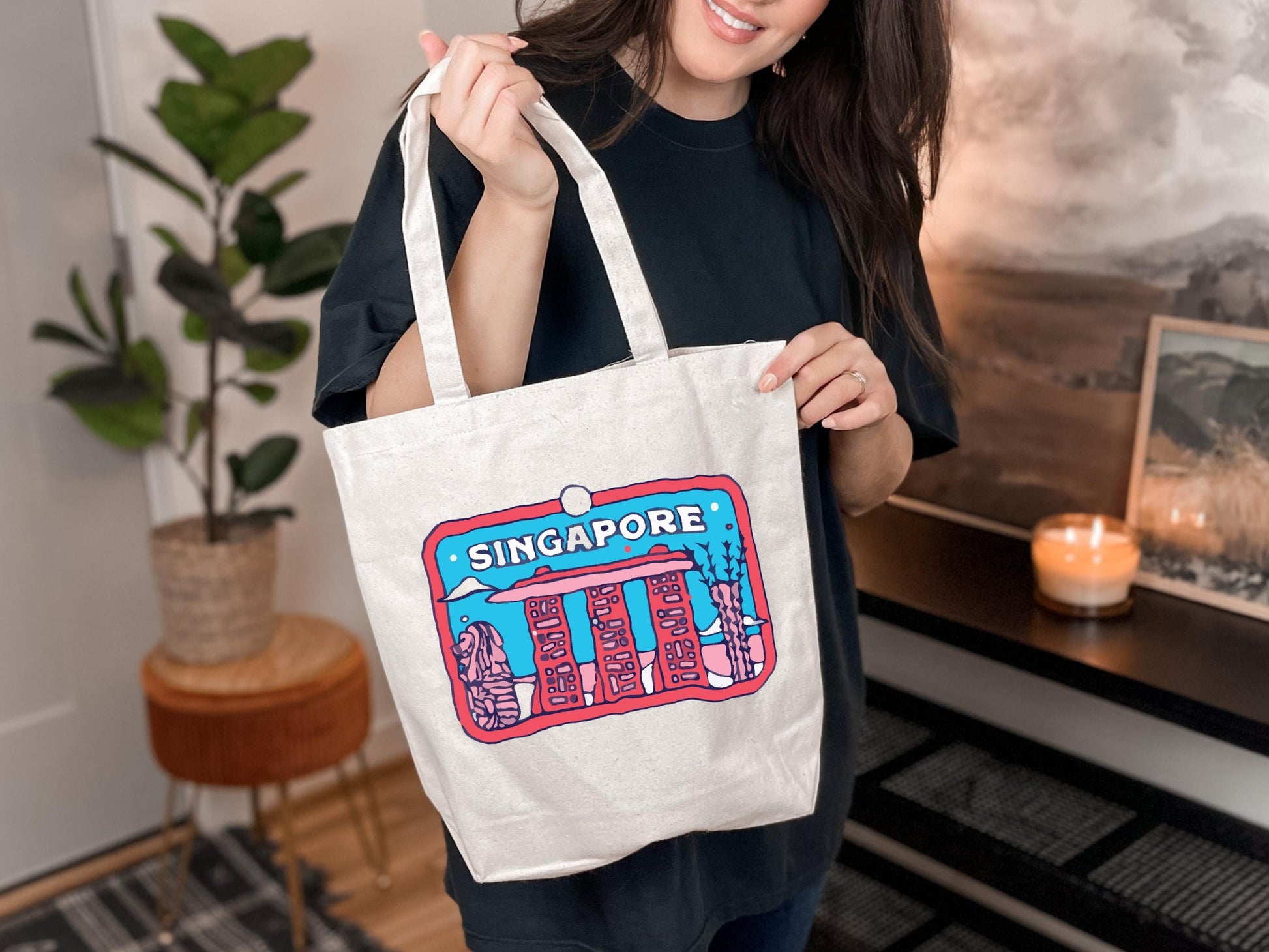 a woman holding a white bag with singapore on it