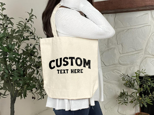 a woman holding a tote bag that says custom text here