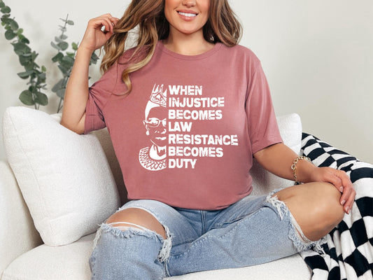 a woman sitting on a couch wearing a t - shirt that says when justice becomes