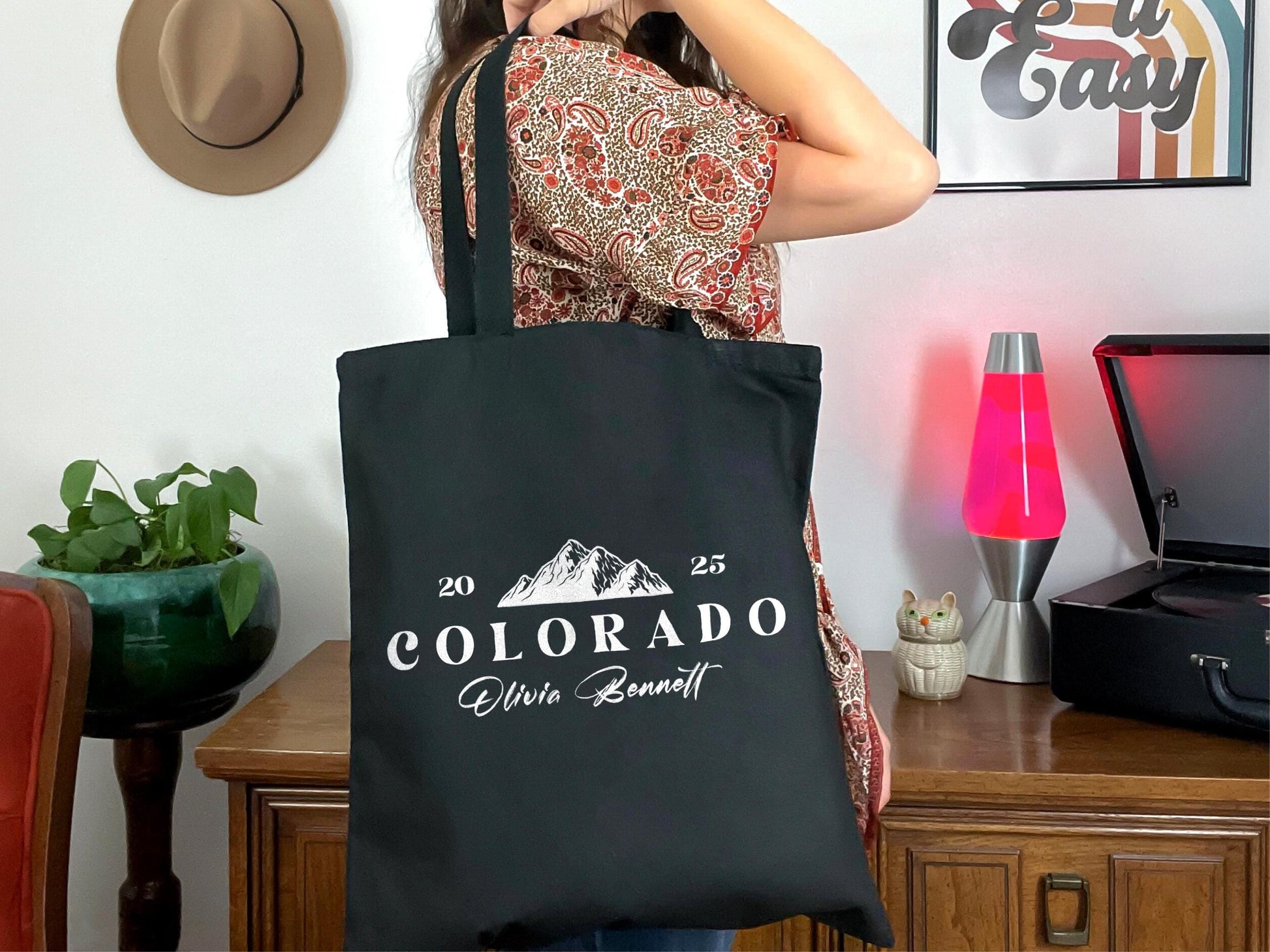 a woman holding a black bag in her hands