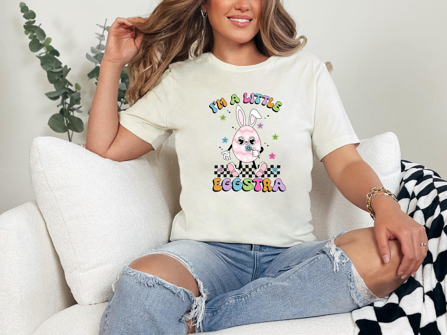 a woman sitting on a couch wearing a t - shirt that says happy easter
