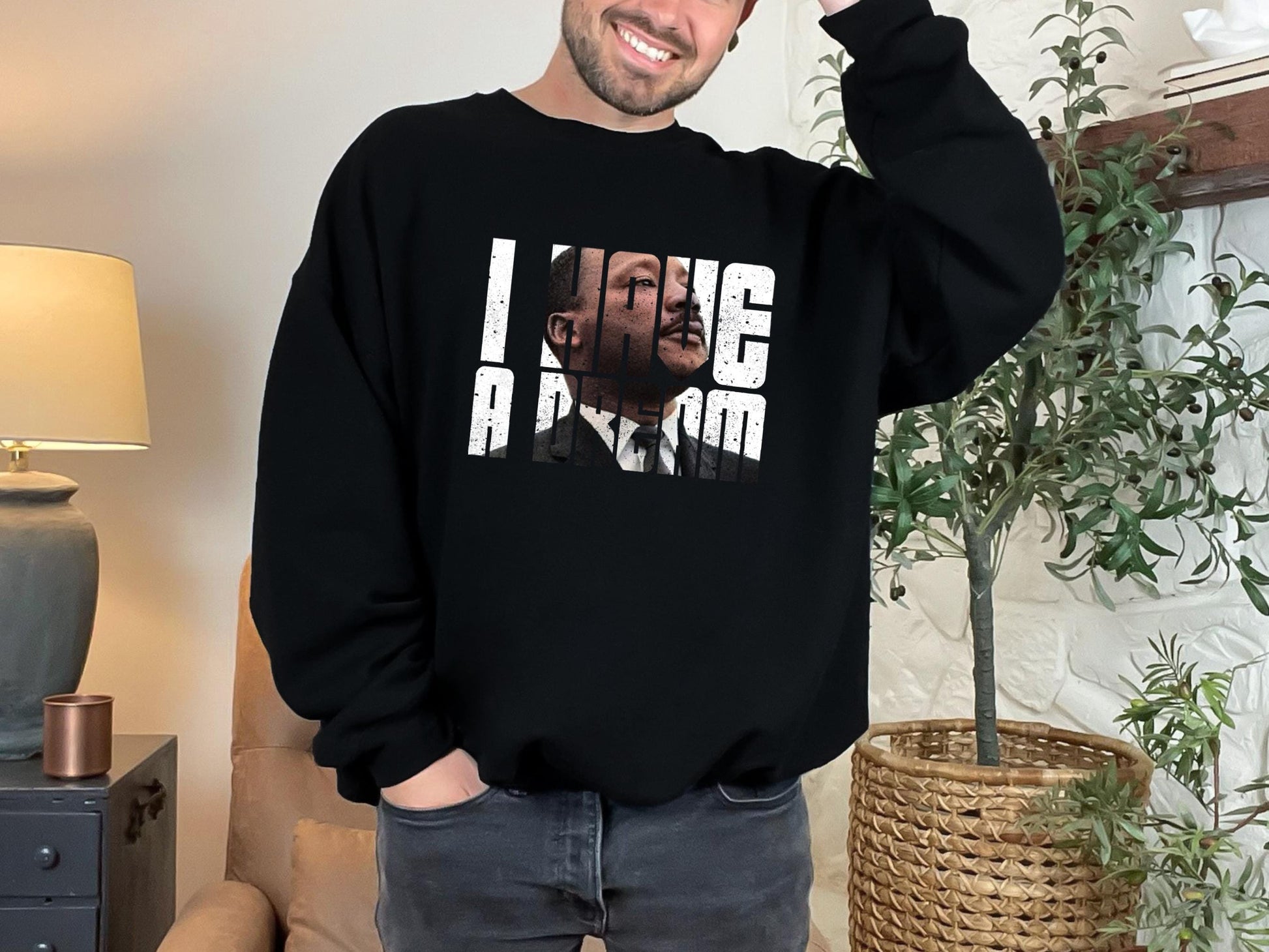 a man wearing a black sweatshirt with a picture of a man on it