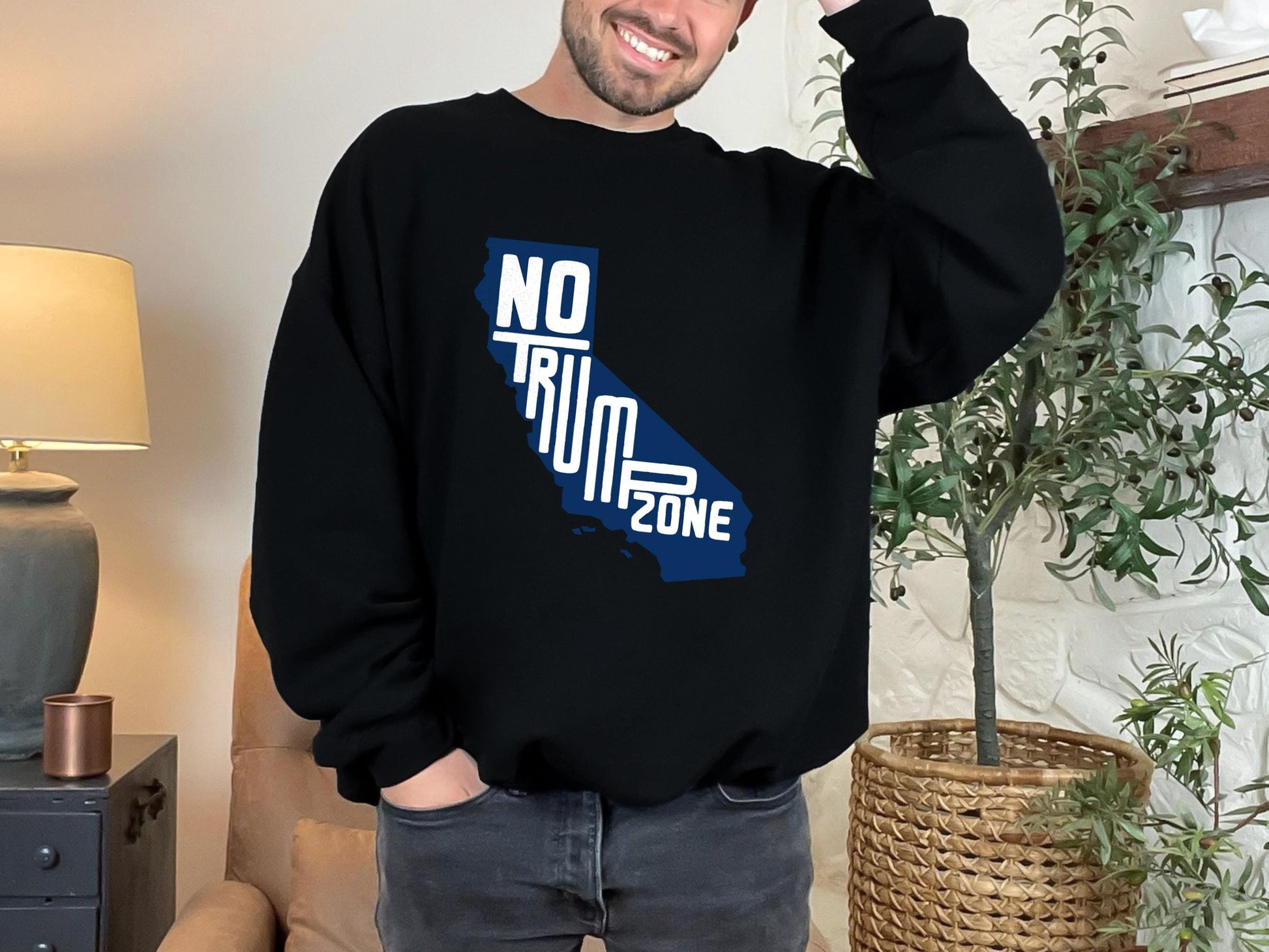 a man wearing a black sweatshirt with the state of california printed on it