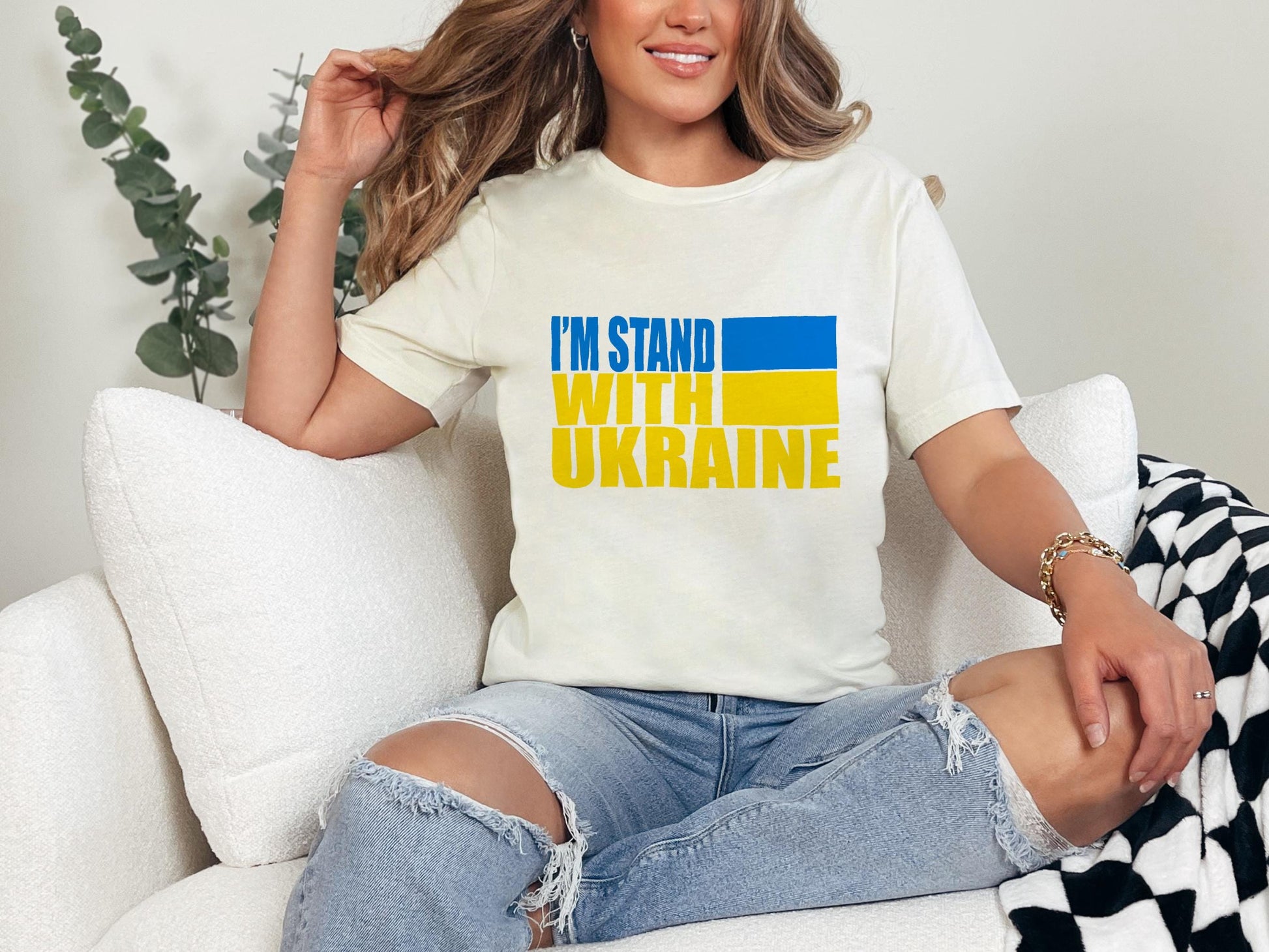 a woman sitting on a couch wearing a t - shirt that says i&#39;m