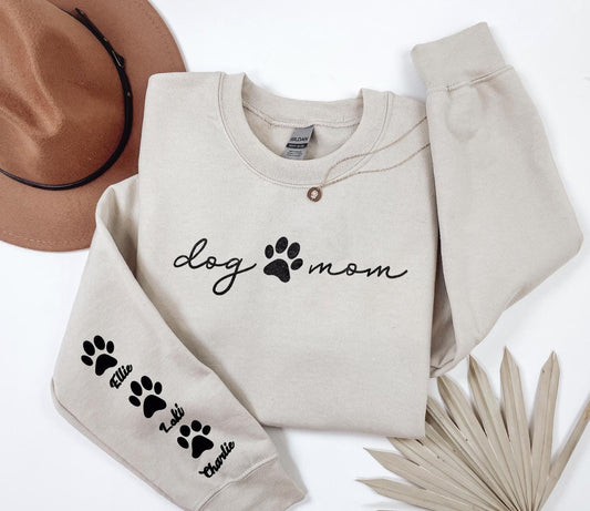 a dog mom sweatshirt with paw prints and a hat