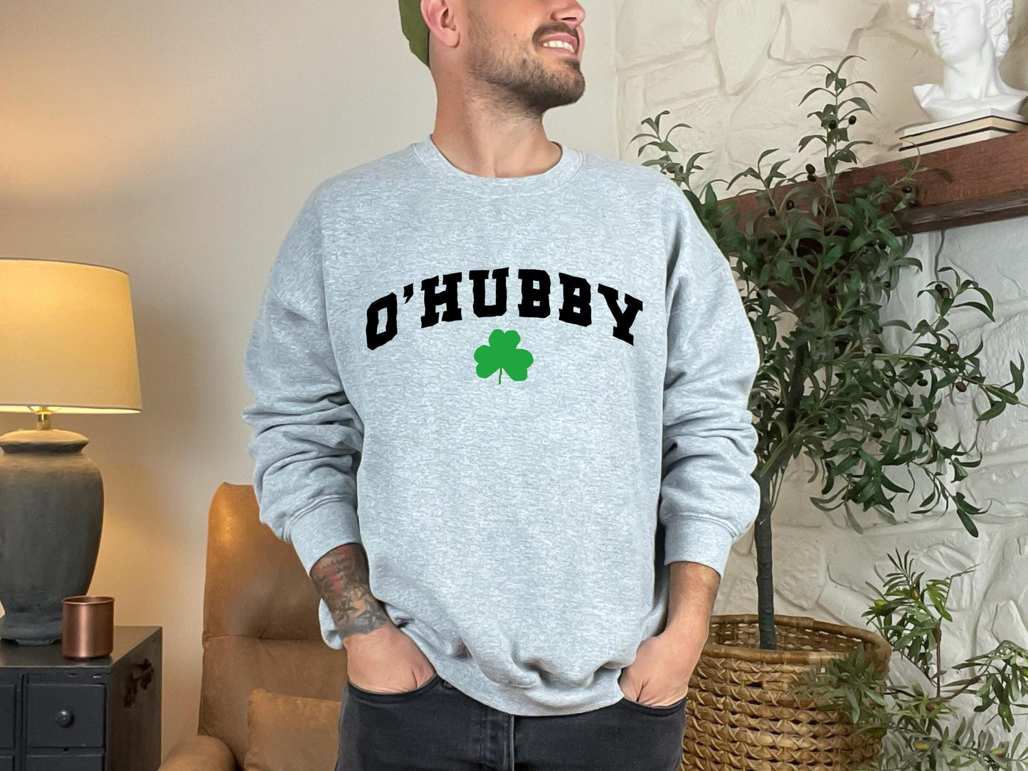 a man standing in a living room with his hands in his pockets