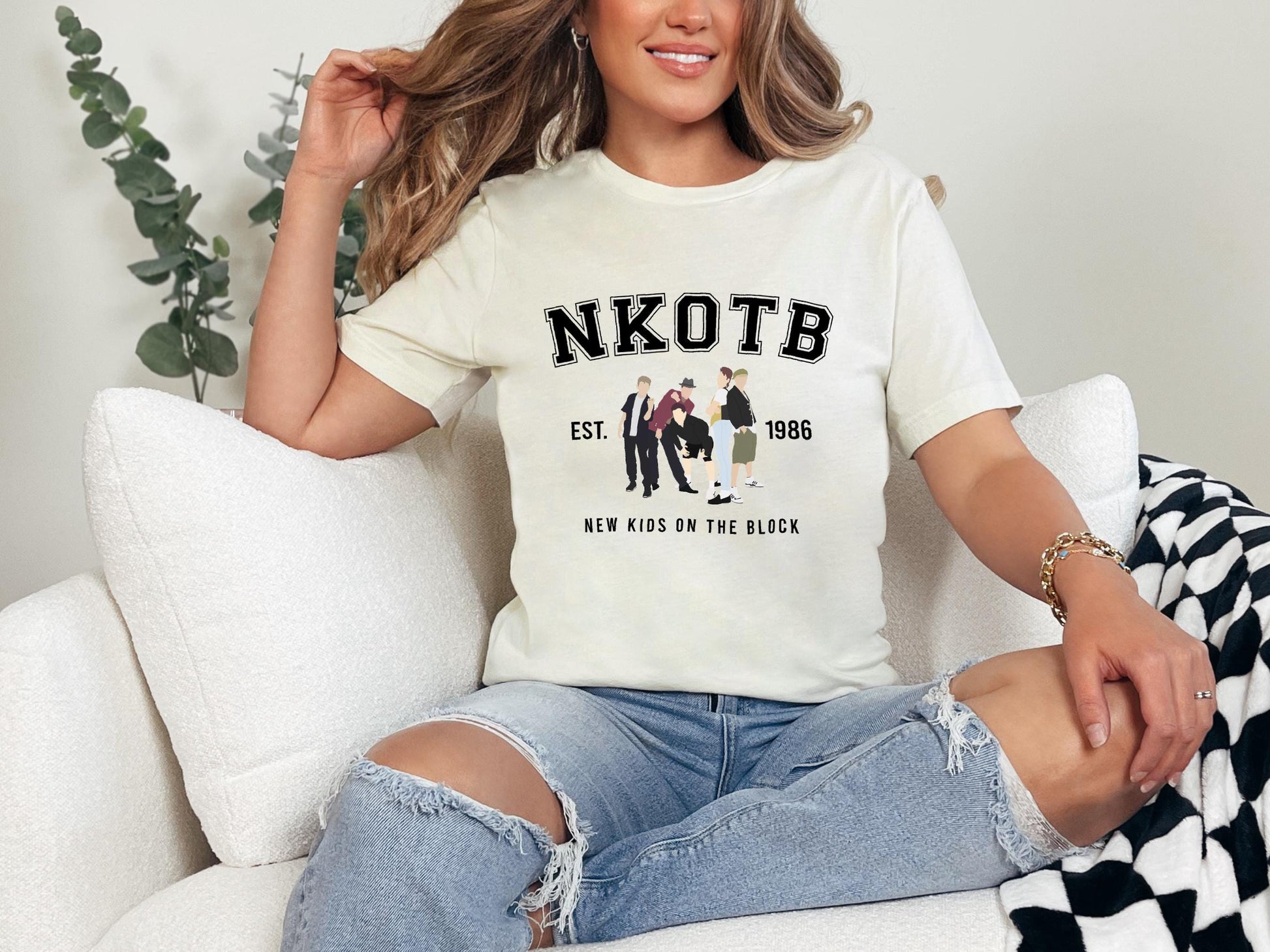 a woman sitting on a couch wearing a white shirt