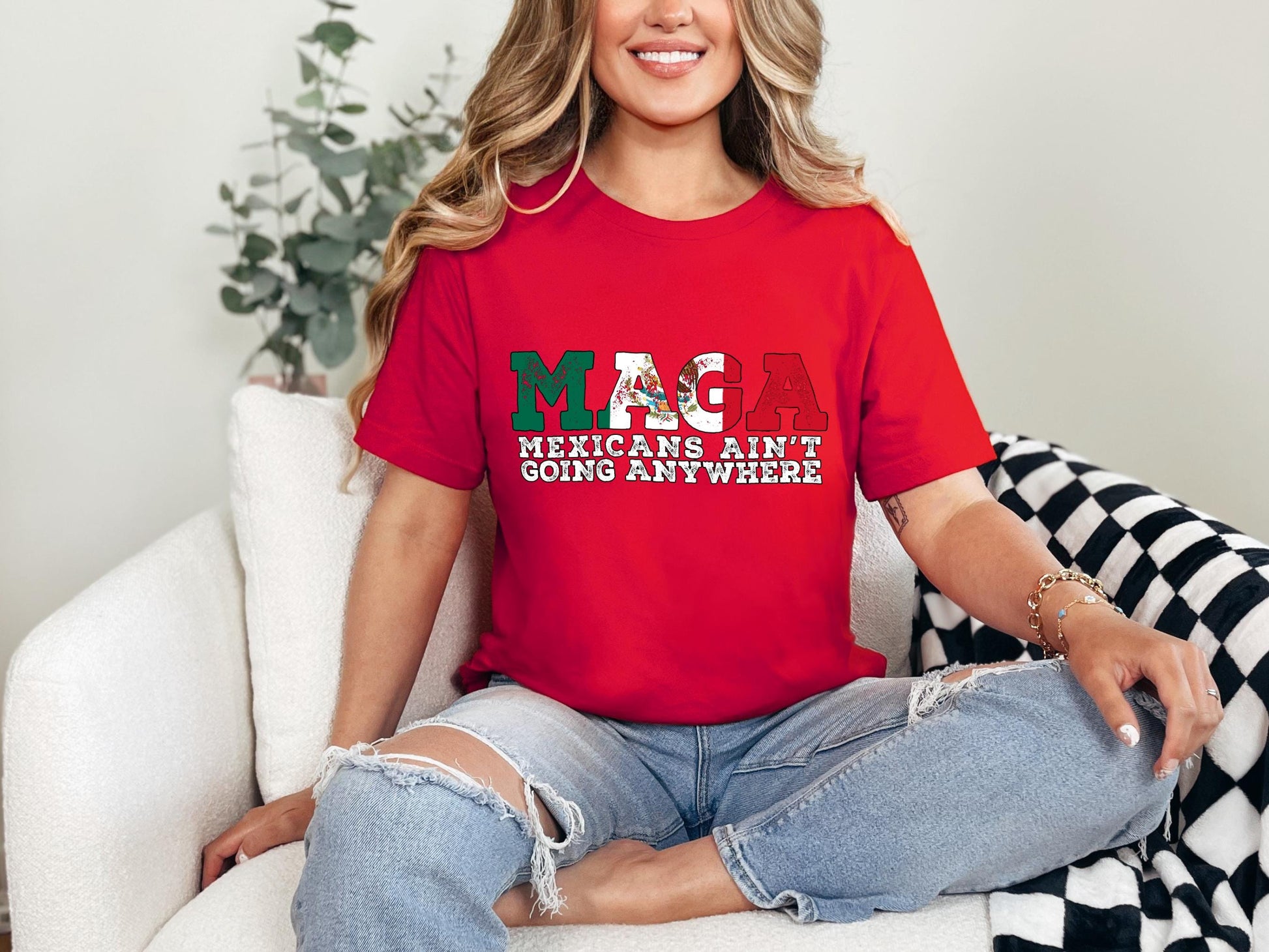 a woman sitting on a couch wearing a red shirt